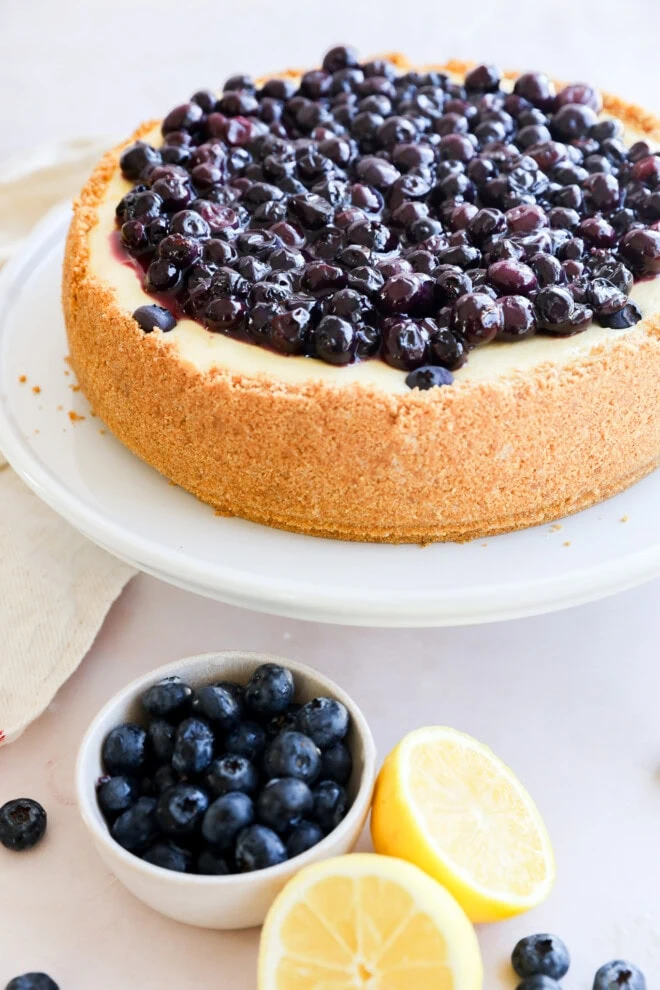 spring summer dessert on cake stand with fresh berries in bowl