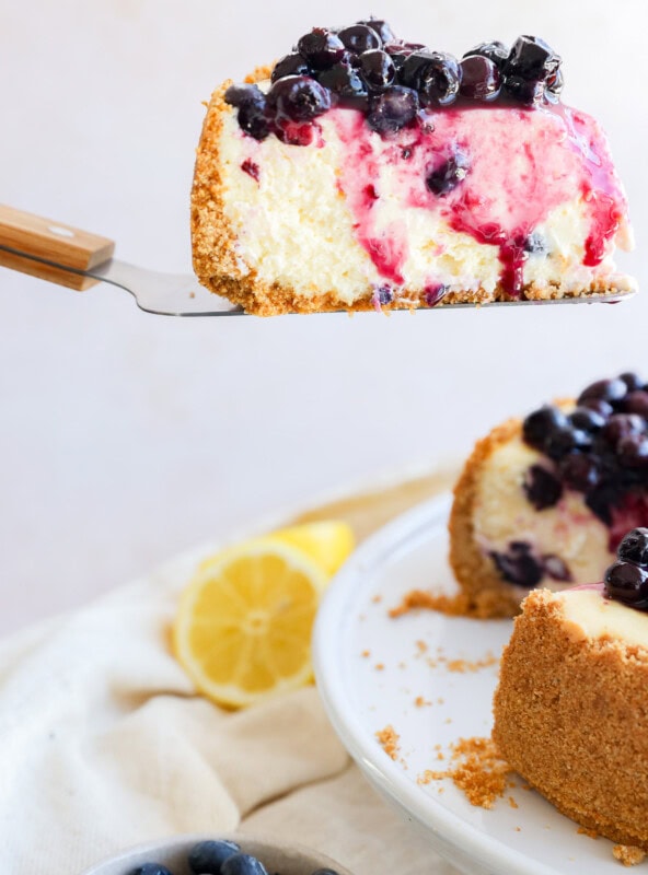 lifting a slice of spring summer dessert from the cake stand with cake knife
