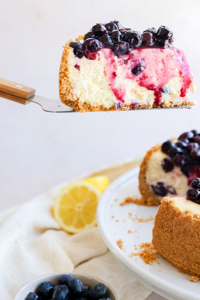 lifting a slice of spring summer dessert from the cake stand with cake knife