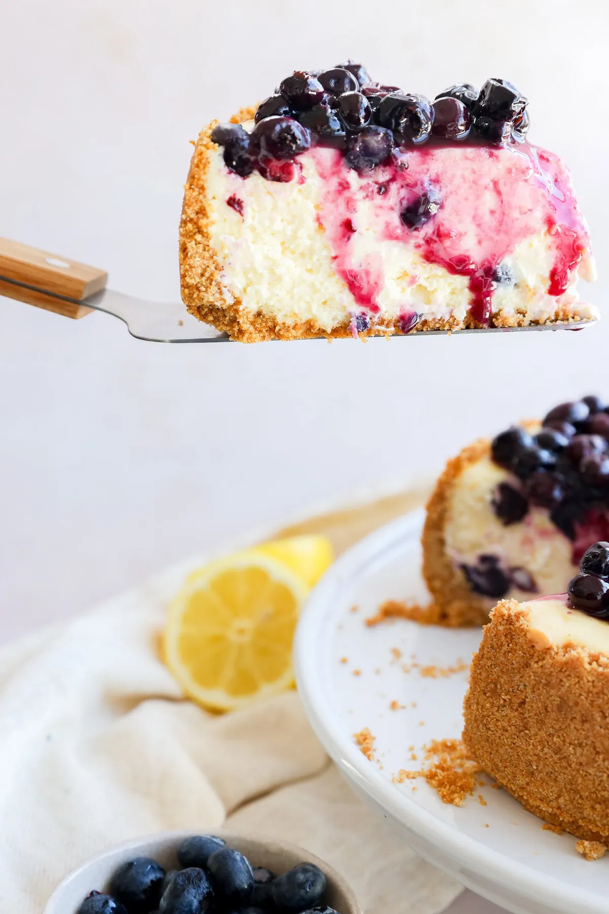 lifting a slice of spring summer dessert from the cake stand with cake knife