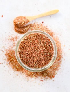 mason jar of seasoning with a spoon to the side