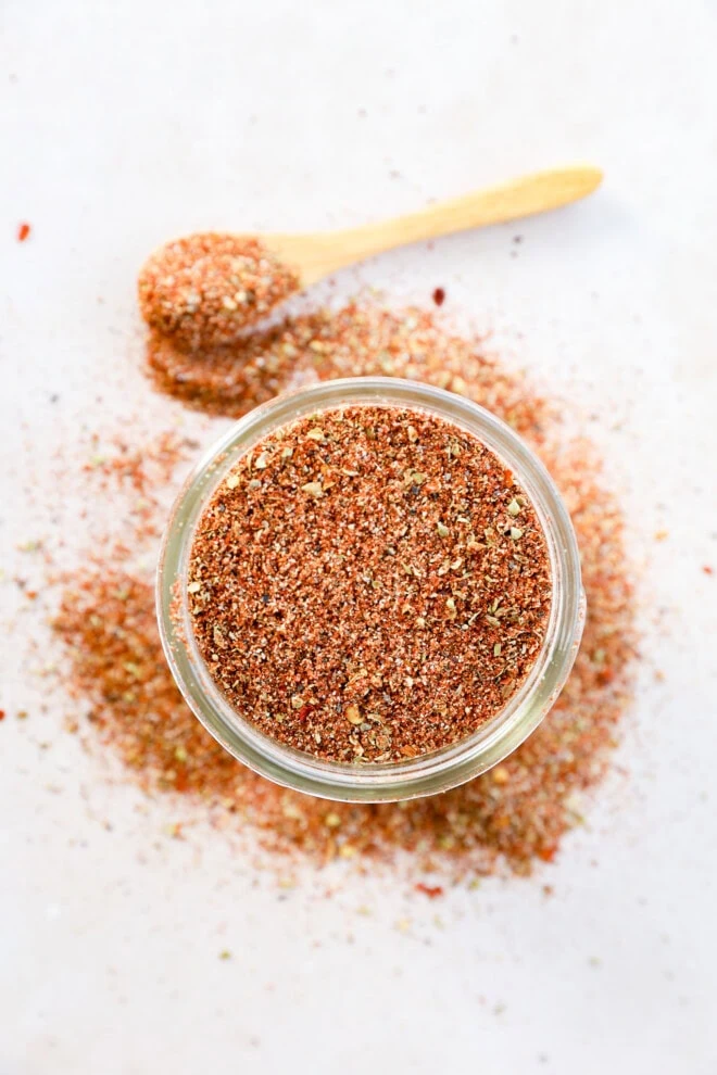 mason jar of seasoning with a spoon to the side