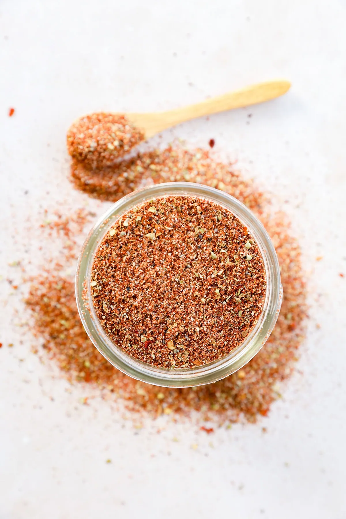 mason jar of seasoning with a spoon to the side
