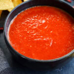 chile de arbol salsa in a bowl with tortilla chips