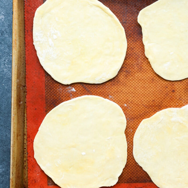 rolled out pastry on baking pan with silicone mat before filling