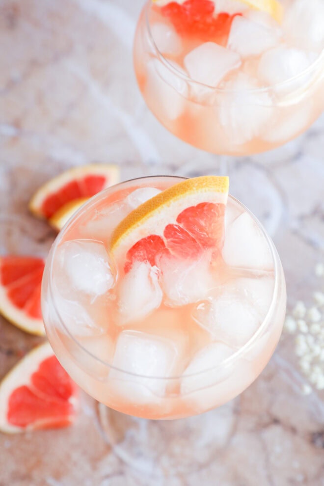 Rosé Elderflower Spritz Cocktail in stemmed wine glasses with fresh grapefruit wedges