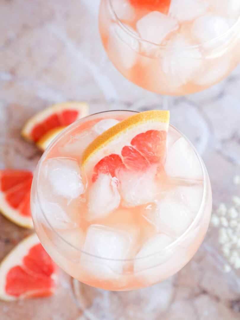 Rosé Elderflower Spritz Cocktail in stemmed wine glasses with fresh grapefruit wedges