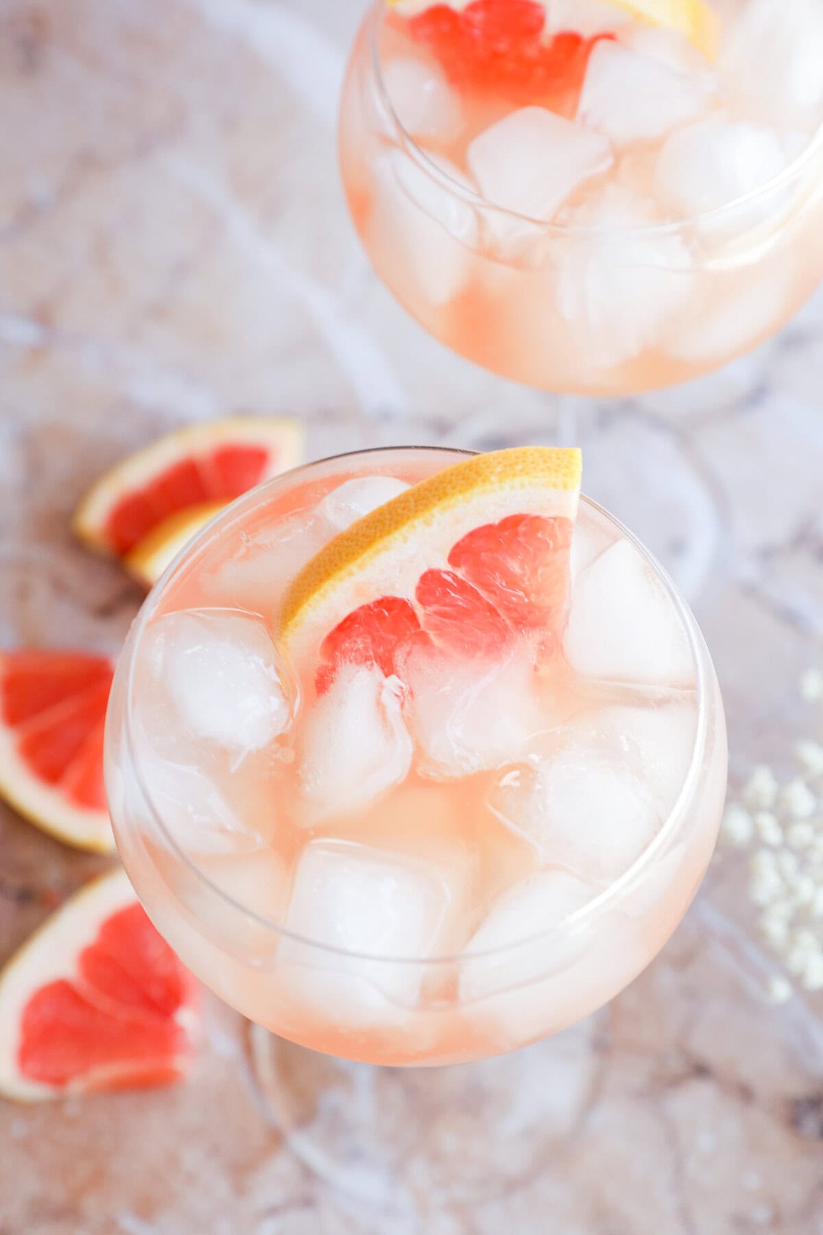 Rosé Elderflower Spritz Cocktail in stemmed wine glasses with fresh grapefruit wedges
