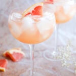grapefruit vodka elderflower liqueur cocktail in stemmed wine glasses