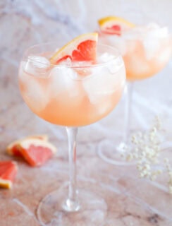 grapefruit vodka elderflower liqueur cocktail in stemmed wine glasses