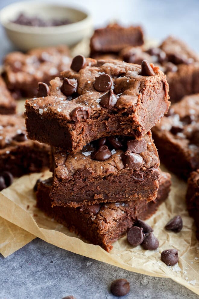 bite take out of a chocolate chocolate chip cookie bar in a stack