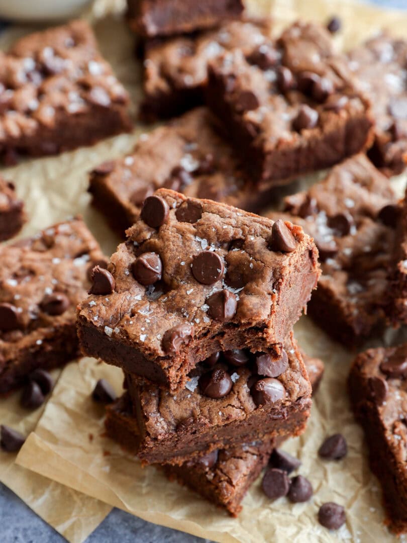 easy decadent dessert squares piled up on brown parchment paper