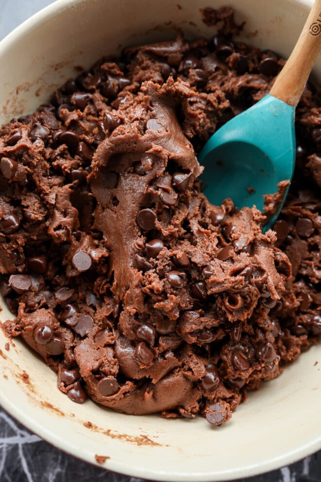 chocolate chocolate chip cookie bar batter in bowl with spatula