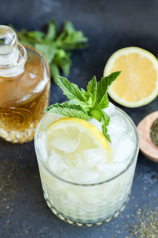 Green tea cocktail over ice with fresh mint and a lemon slice