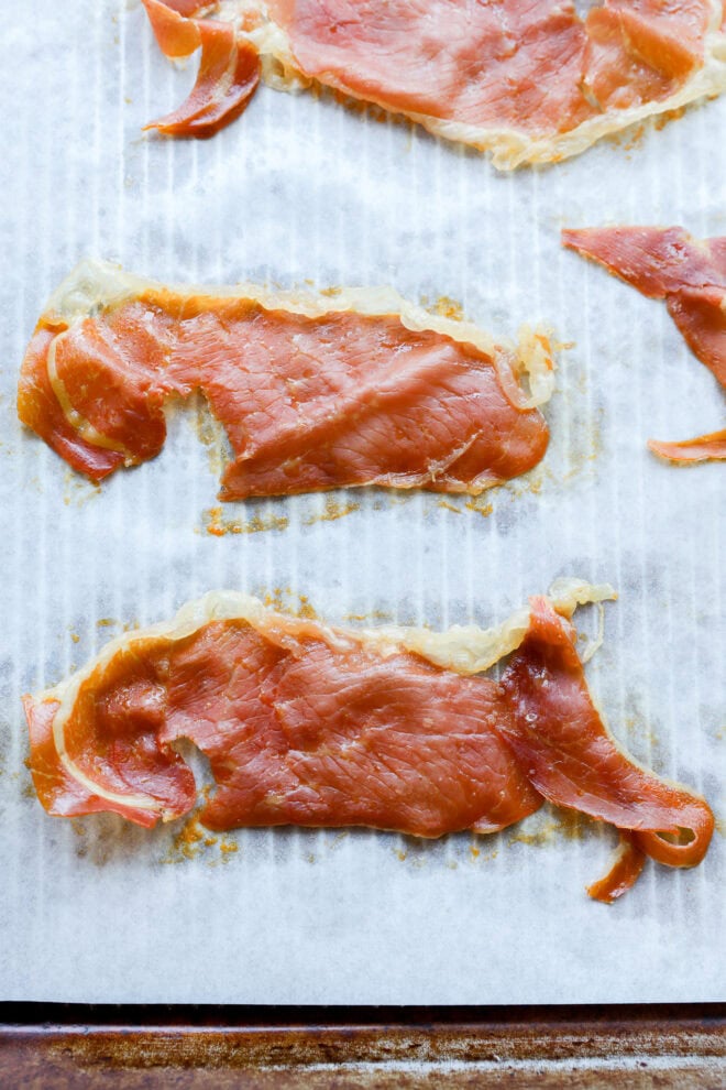 baked crispy prosciutto on baking sheet with parchment paper