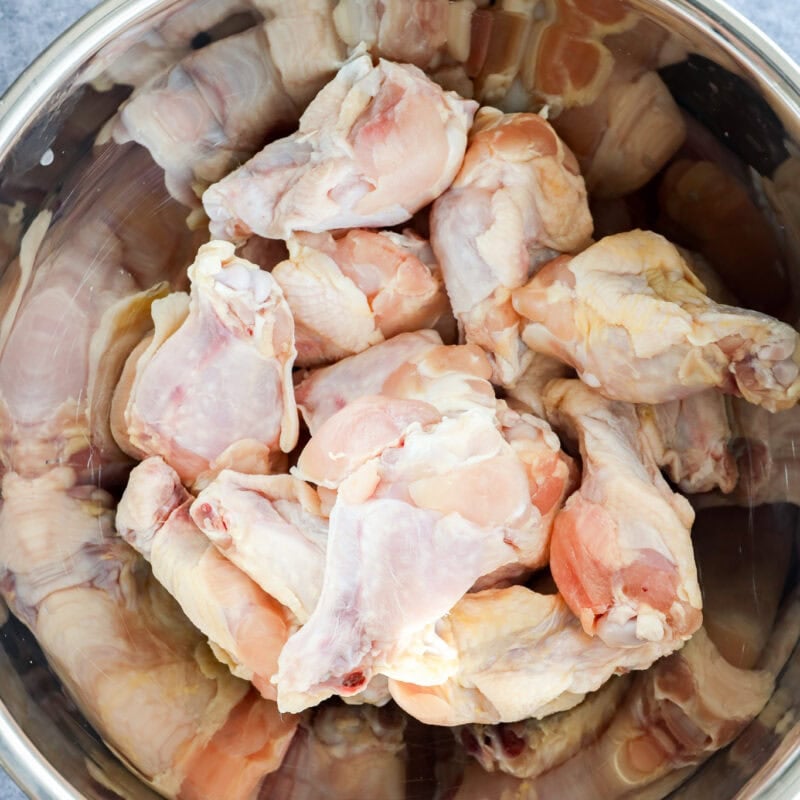 raw chicken wings in large metal bwol