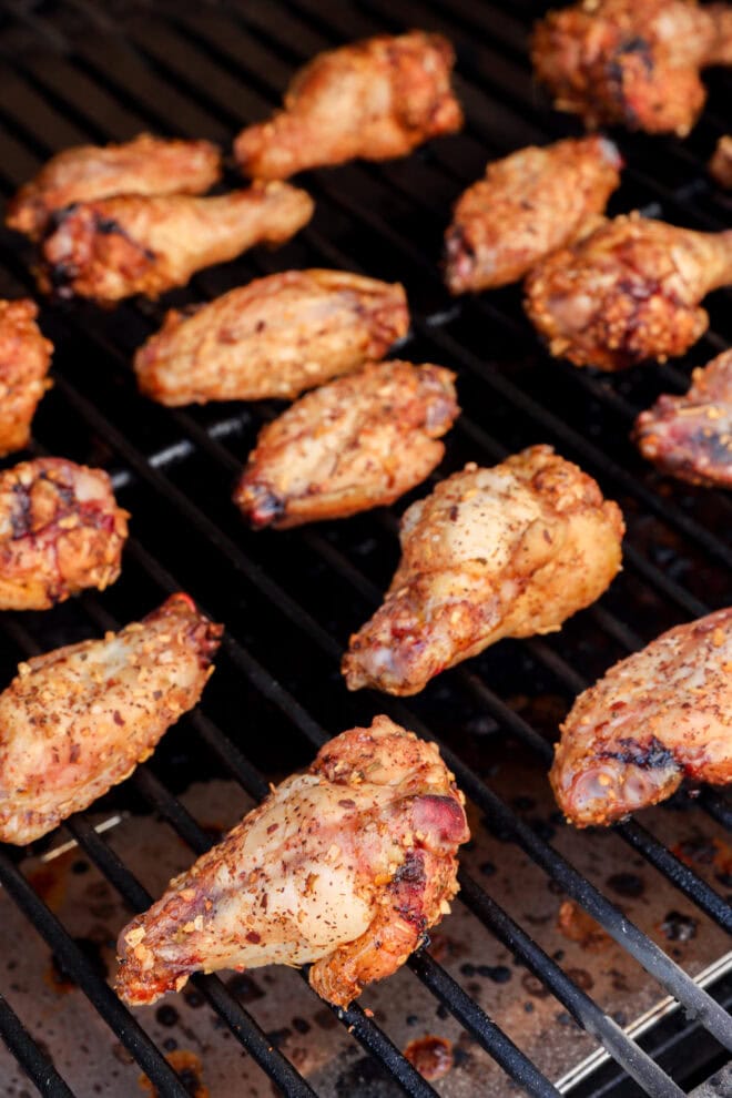 smoked chicken wings on smoker grate golden brown