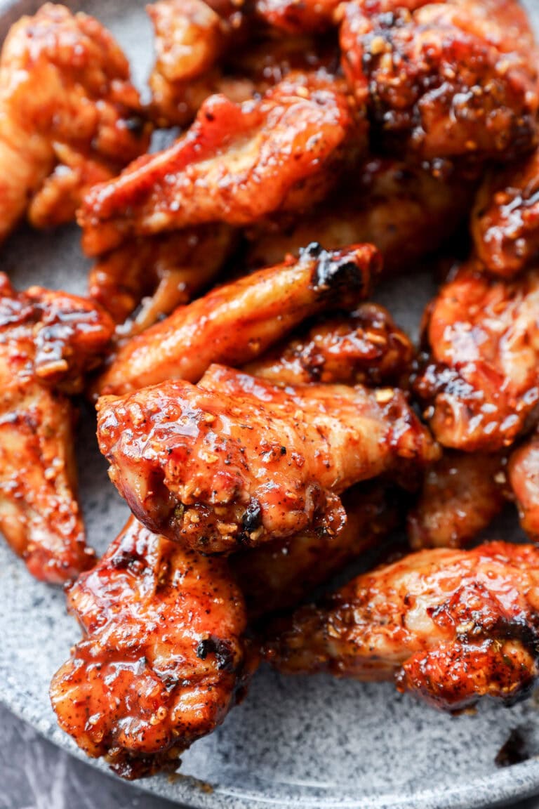 plate of smoked chicken wings tossed with bbq sauce