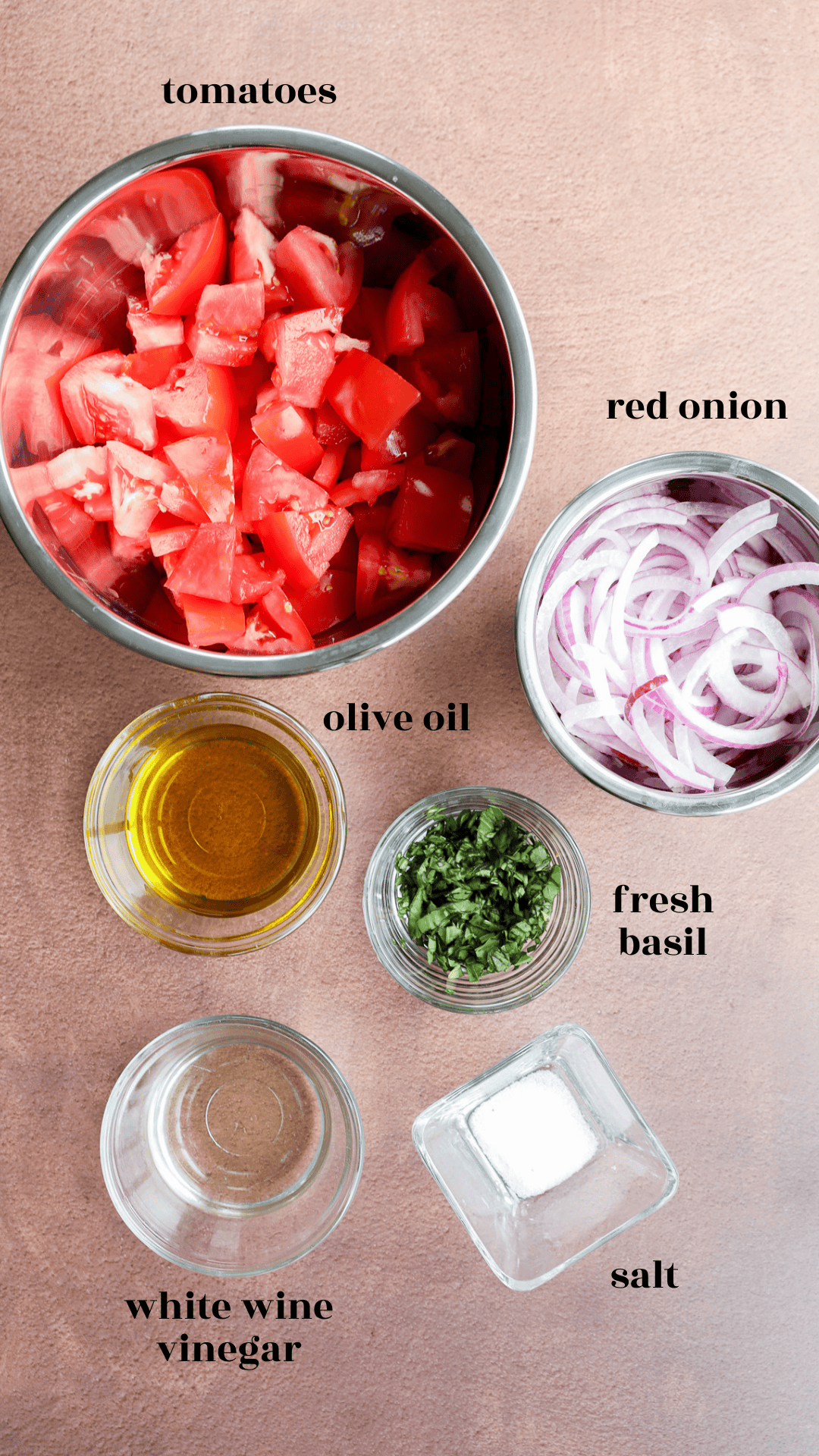 Tomato onion salad ingredients in bowls with text labels