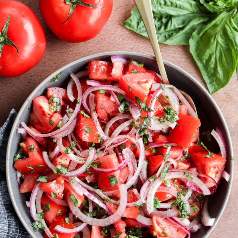 fresh summery vegetarian side dish with bowls and fresh basil