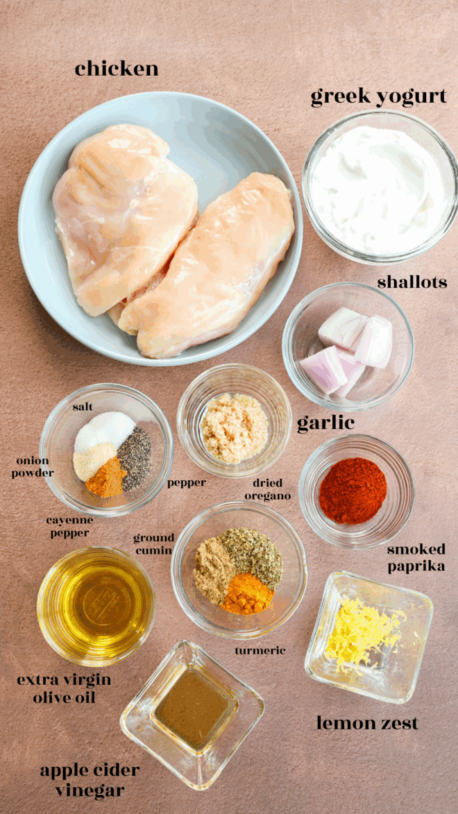 Chicken greek yogurt marinade ingredients in bowls with text labels of the different ingredients