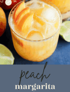 A refreshing glass of peach margarita with ice and juicy peach slices, surrounded by lime wedges and fresh peaches. Text reads peach margarita and Cake n Knife in the corner.