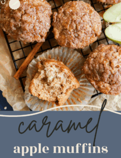 Overhead view of caramel apple oatmeal muffins on a cooling rack with one muffin cut in half, showing its moist texture. Green apple slices and a cinnamon stick are nearby. Text overlay reads “caramel apple muffins.”.
