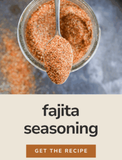 A spoonful of fajita seasoning held above a jar filled with the spice blend, with text below reading “fajita seasoning, get the recipe, Cake n Knife.”.