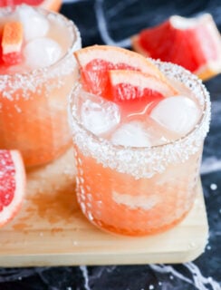Two glasses with salt-rimmed edges are filled with a refreshing drink and elegant touch.