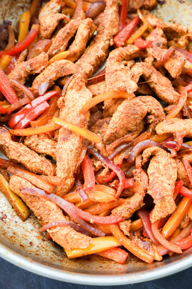 Saut&eacute;ed strips of seasoned chicken, red and yellow bell peppers, and red onions are cooked until slightly caramelized&mdash;perfect for a flavorful chicken fajitas wrap.